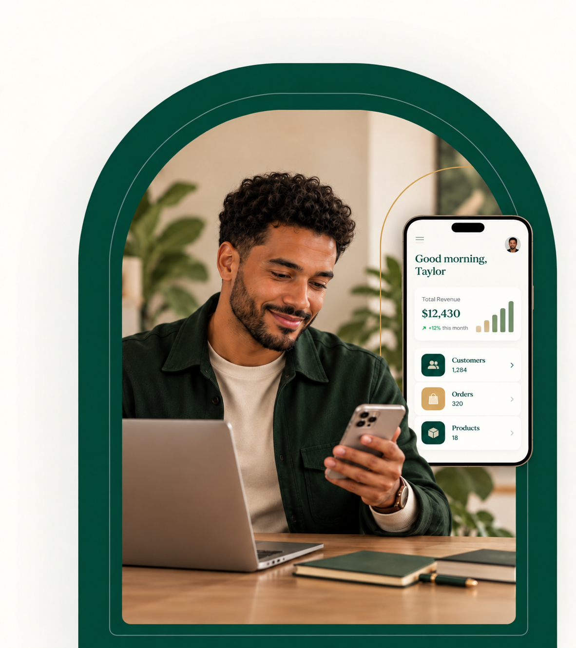 Biracial man reviewing an app dashboard and mobile product screens at his desk